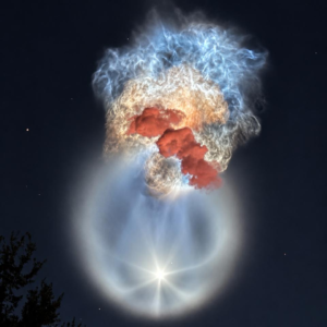 Sunlit Falcon 9 exhaust forms a glowing jellyfish-shaped plume above silhouetted trees after the SpaceX CRS-35 launch