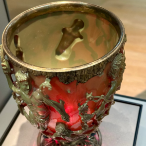 The ancient Lycurgus Cup viewed from above, with green carved figures surrounding ruby-red glass at the British Museum