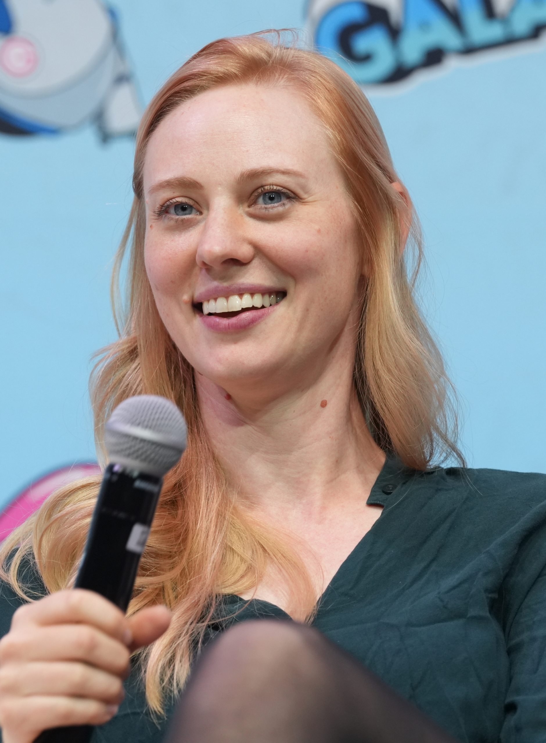Deborah Ann Woll speaking into a microphone at GalaxyCon Raleigh in 2024