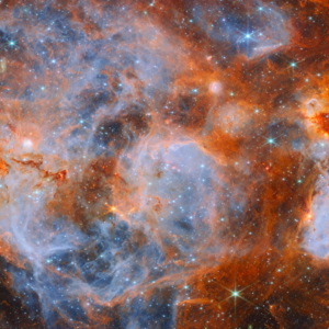 James Webb infrared panorama of N159 showing blue ionized bubbles, orange clouds, dark molecular filaments and thousands of stars