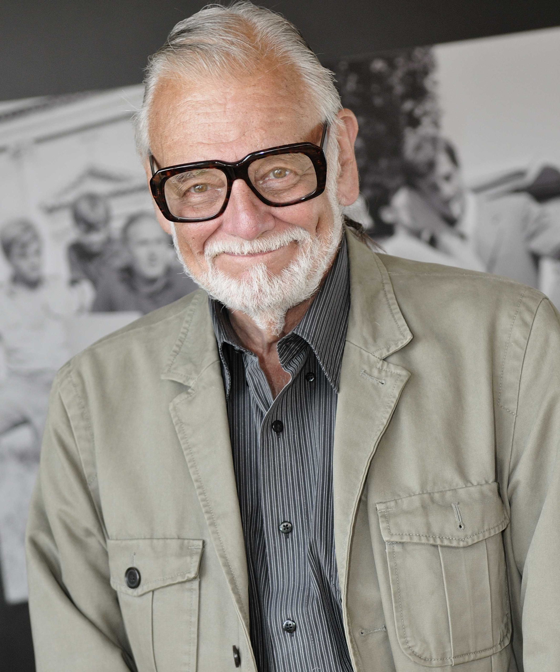 George A. Romero wearing glasses and a light jacket at the 2009 Venice Film Festival.